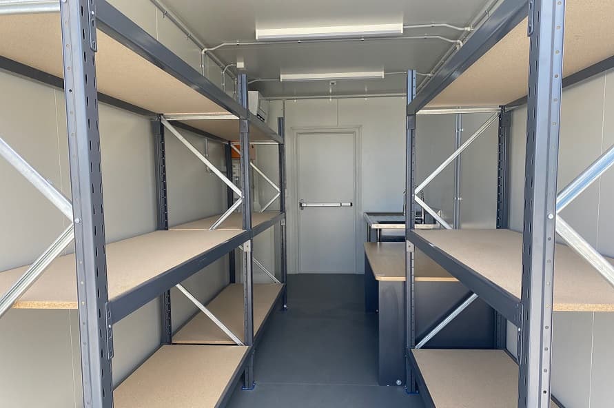20ft shipping container modified with shelving, sink, electrics and work desk from Container Traders