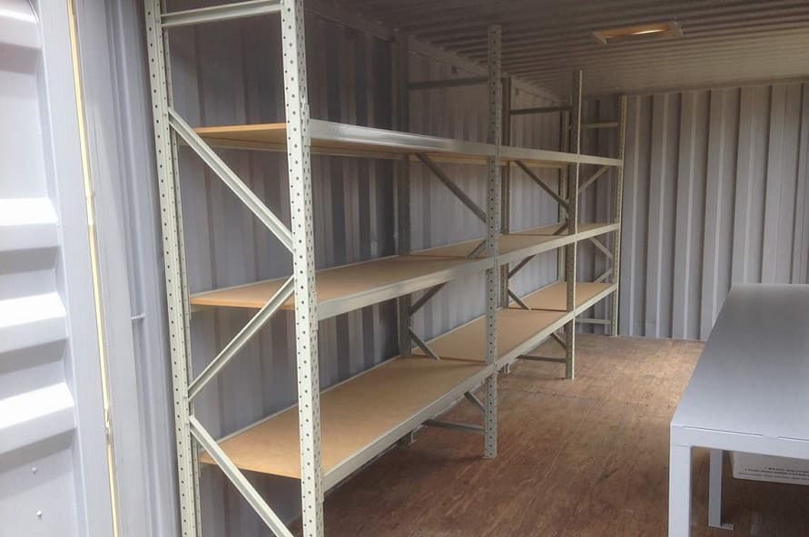 20ft shipping container modification for storage with shelving and bench from Container Traders
