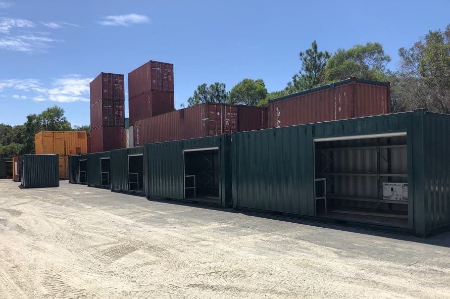 20ft shipping container modified storage and workshop with roller door, benches and shelving from Container Traders
