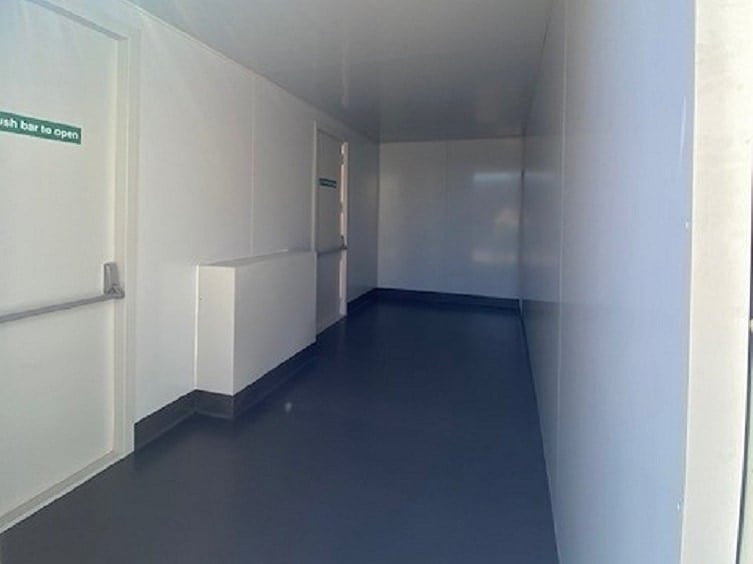 Modified thermal switch room shipping container internal insulation coved flooring emergency doors from Container Traders